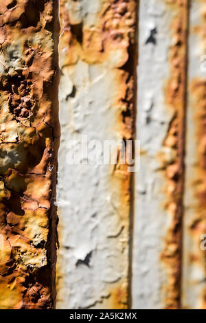 Close up of old rusty iron bridge railing. Peeling paint on metal. Stock Photo