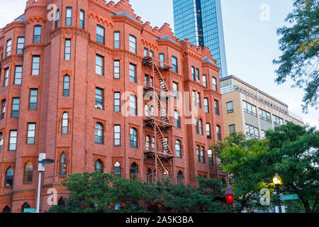 Typical external metal fire escape ladders on a red brick building in Back Bay and John Hancock Tower, Boston, Massachusetts, New England, USA Stock Photo