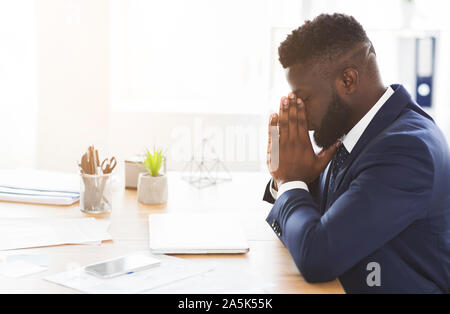 Young exhausted businessman having stress at work Stock Photo