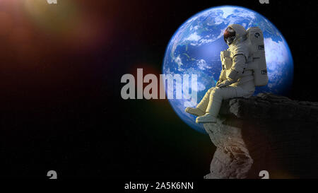 astronaut sitting on a cliff on the Moon in front of planet Earth Stock Photo