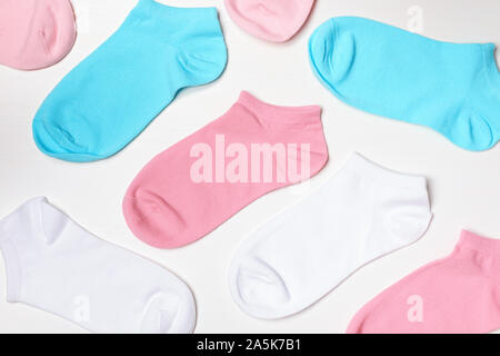 Multi-colored socks on a white background. Top view. Stock Photo