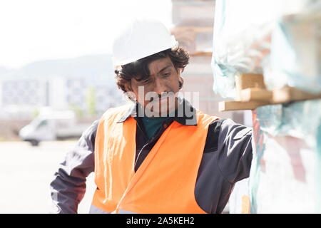 Male engineer on construction site inspecting construction materials Stock Photo