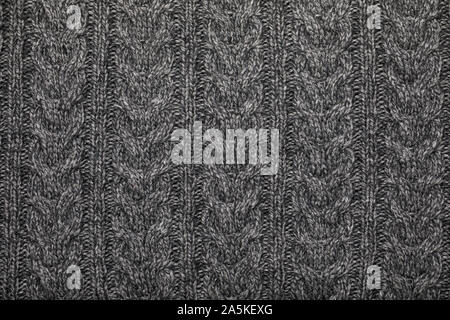 Grey melange knitted fabric with cable pattern made of heather mixed yarn background Stock Photo