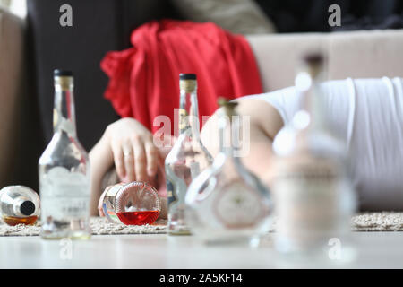 Drunken man lying on coach Stock Photo