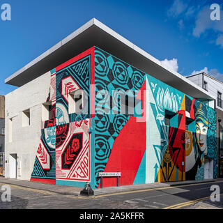 New giant mural designed and produced by Shepard Fairey on Whitby Street, London Stock Photo