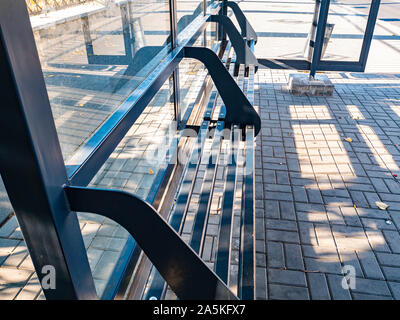 Glass public transport stop with a bench. Background. Stock Photo