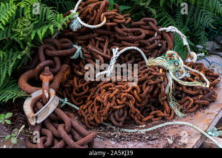 A pile of rusty chains and rope Stock Photo