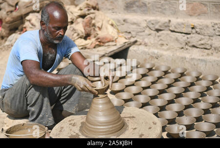 A potter prepares clay lamp or diya on potter's wheel in his residence ahead of Diwali festival in Beawar, Rajasthan. Photo/Sumit Saraswat Stock Photo