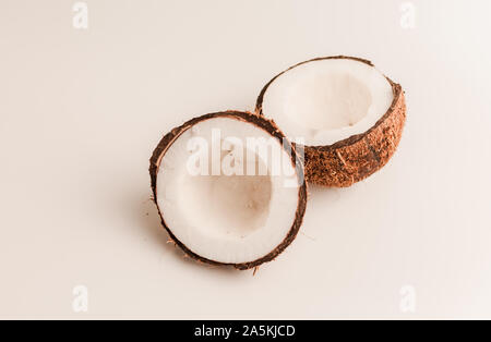 ugly organic coconut on a white background, isolate. a broken nut in a shell the white insides of a coconut, which began to decompose and covered with Stock Photo