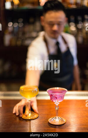 Bartender serving cocktails Stock Photo