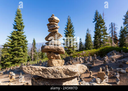 Close up of stacked stones with pine trees behind in Sequoia National Park, California USA Stock Photo