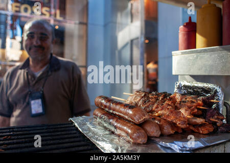 Manhattan in New York City Easter snow covers 5th Avenue hotdog seller street vendor with large cart Stock Photo