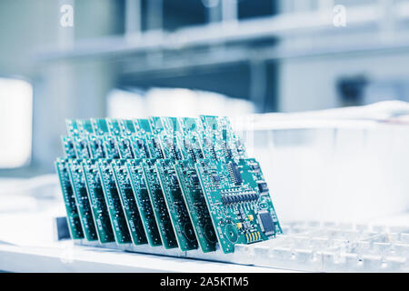 Computer boards stand in a row. Computer techologies. Spare parts. Modern technologies. Stock Photo