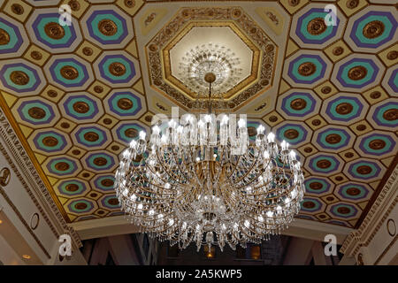 Large glass chandelier hanging in Les Cours Mont-Royal fashion mall in the former Sheraton Mount Royal Hotel, Montreal, Quebec, Canada Stock Photo