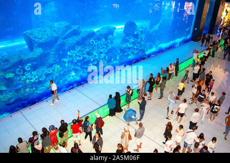 Dubai / UAE - October 19, 2019: Huge aquarium in Dubai mall with crowd of tourists. The largest mall in the world. Aquarium. Stock Photo