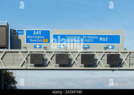 UK motorway sign showing directions to A49 Warrington, Newton and M62 Liverpool, St Helens, Southport (M57) Stock Photo