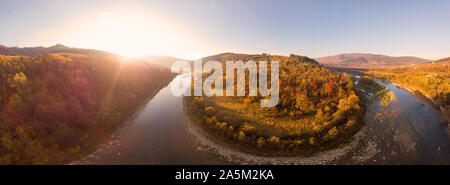 180 degrees panoramic landscape colorful autumn in Carpathians, Eastern Beskids. Aerial drone view of scenic landscape, river, mountains and forests Stock Photo