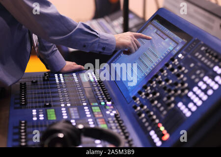 Operator working with digital mixing console using touch screen. Selective focus. Stock Photo