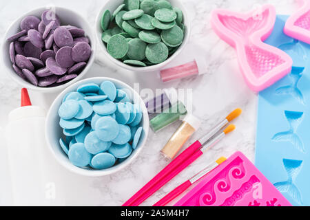 Flat lay. Ingredients to make chocolate mermaid molds from the chocolate chips. Stock Photo