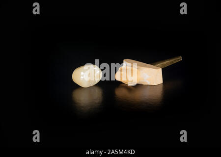 Dental veneers, ceramic and zirconium crowns of teeth close-up macro isolate on black background. Laboratory technical production  prostheses Stock Photo