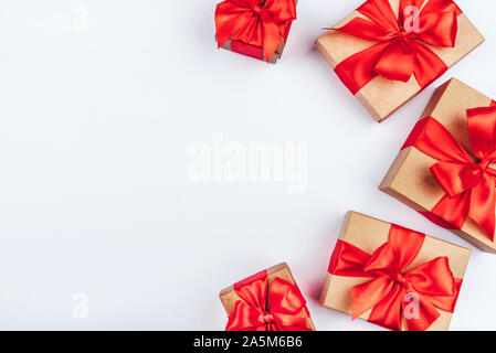 Frame of cardboard gift boxes with red bows. Stock Photo