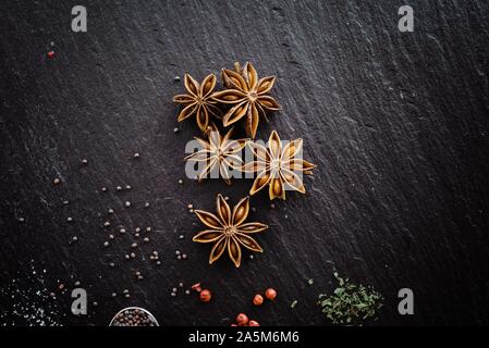 Star Anise and spices on a chopping board Stock Photo