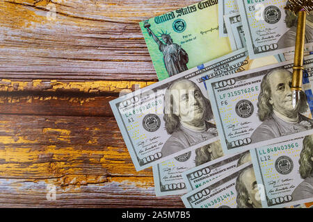 Hundred US dollar bills and tax return check and 1040 individual income form US refund Stock Photo