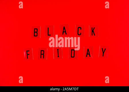Black Friday sale tag on red background. Stock Photo