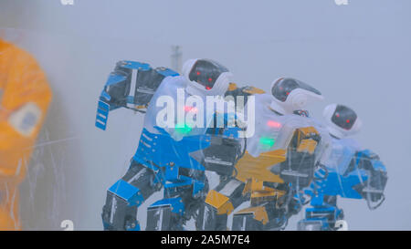 Humanoid robots dancing at robotic show Stock Photo