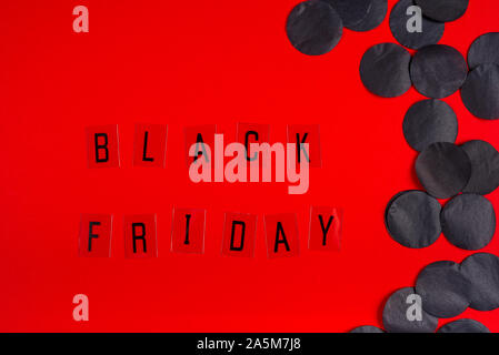 Black Friday sale tag on red background. Stock Photo
