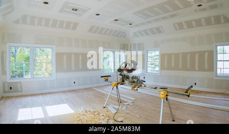 Cutting wooden trim board on with circular saw works on remodeling home Stock Photo