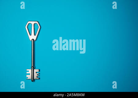 Key on blue background. Minimal creative style Stock Photo