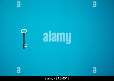 Key on blue background. Minimal creative style Stock Photo