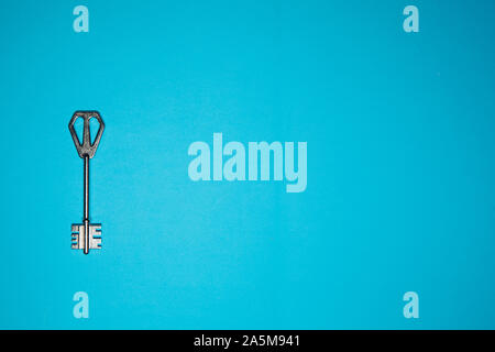 Key on blue background. Minimal creative style Stock Photo