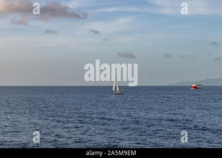 Sailboat and ferry boat at sea in Saint Vincent and the Grenadines Stock Photo