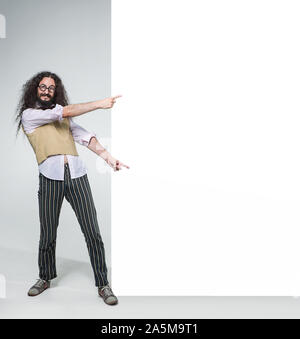 Eccentric guy pointing on the commercial, empty board Stock Photo