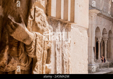 Woman lying down on stone ledge in church, Arles, France Stock Photo