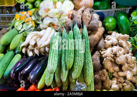 Various vegetables on the counter. organic fresh fruits and vegetables on grocery counter. Selling vegetables in Asia. Stock Photo