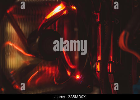 Computer fan and electronic components in red light from inside the tower. Stock Photo
