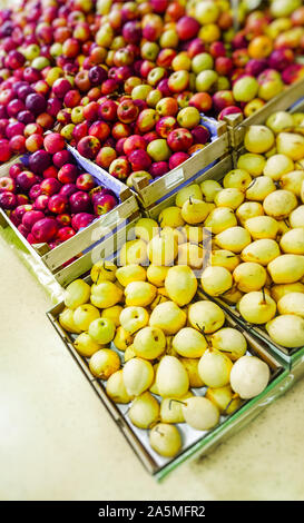 apples and pears in wooden containers Stock Photo