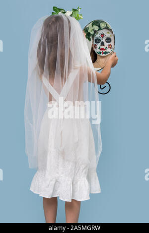 Little dead bride looks in the mirror and terrifies Stock Photo