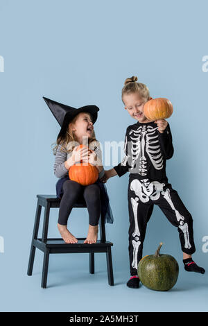 Brother and sister play and joke in halloween costumes Stock Photo