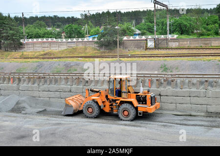 Wheel loader bulldozer with bucket on a construction site. Clearing the ground for digging the foundation pit Stock Photo