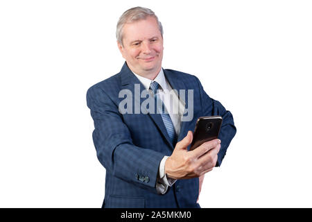 An elderly man communicates via video communication. Isolated on a white background. Stock Photo