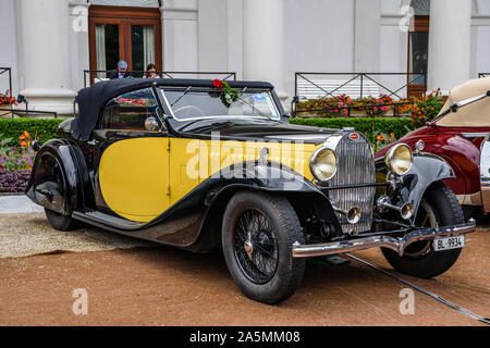 BADEN BADEN, GERMANY - JULY 2019: yellow black BUGATTI TYPE 57 cabrio roadster 1934, oldtimer meeting in Kurpark. Stock Photo