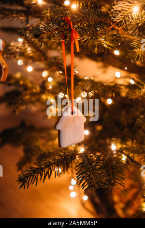 Christmas tree decorated with gingerbread cookies and garland Stock Photo