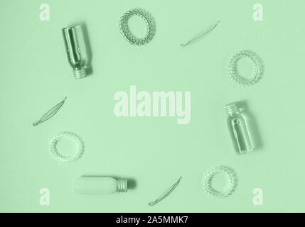 Flat lay of hair care products and styling items on trendy mint background. Women beauty and beauty salon cosmetics concept. Copy space. Stock Photo