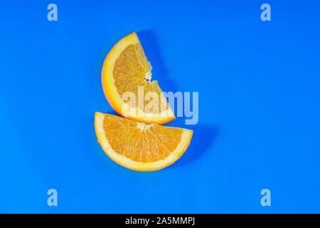 Orange fruit slides on a blue background Stock Photo