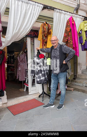 Posed portrait of a man who owns & operates a women's clothing store in the old town of Piran, Slovenia. Stock Photo