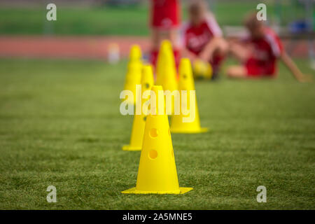 Yellow Soccer Training Cones On Grass Field Youth Football Players On Training In The Background School Soccer Outdoor Practice For Elementary Age K Stock Photo Alamy